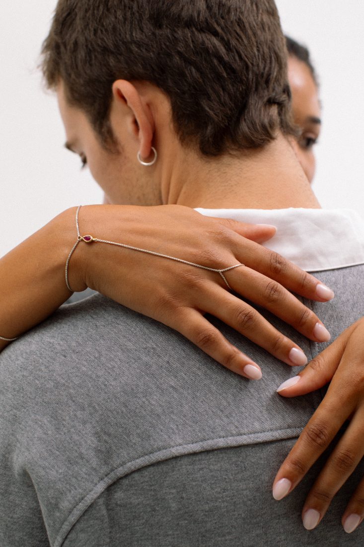 Gold-plated hand chain in a hug