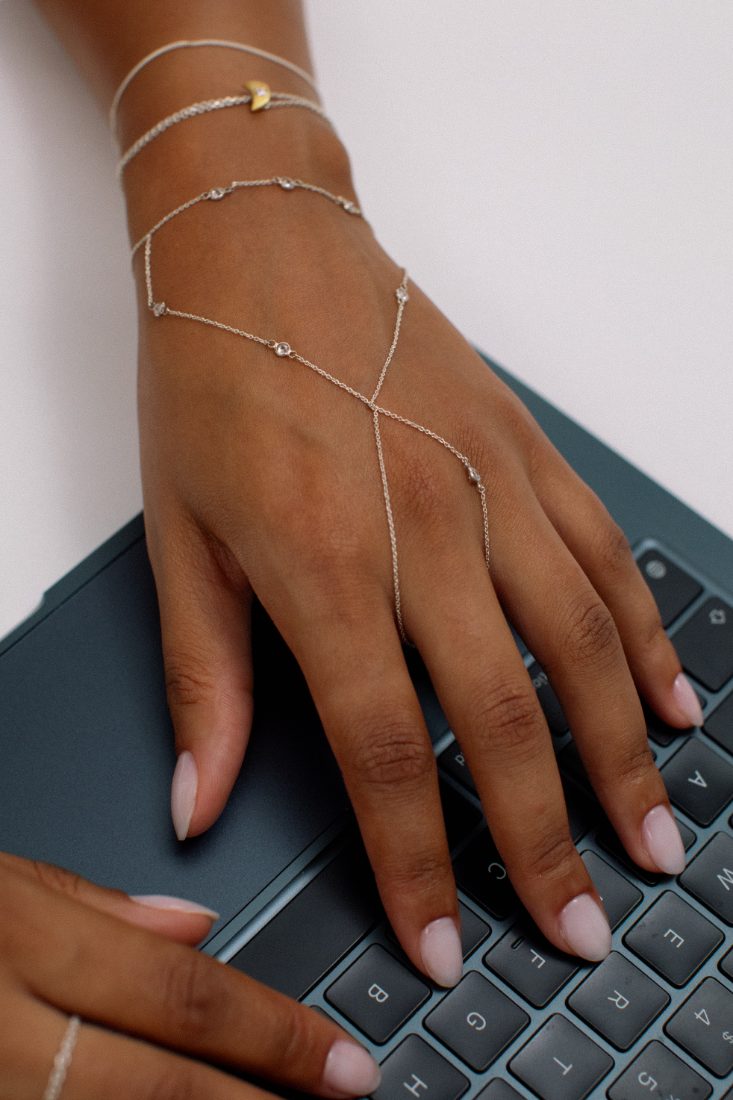 Silver hand chain on a keyboard